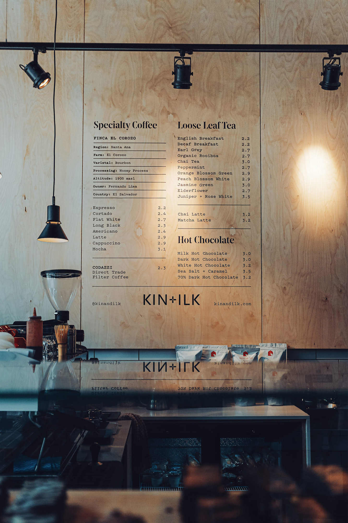 Stylised menu. Black type on light wood. 